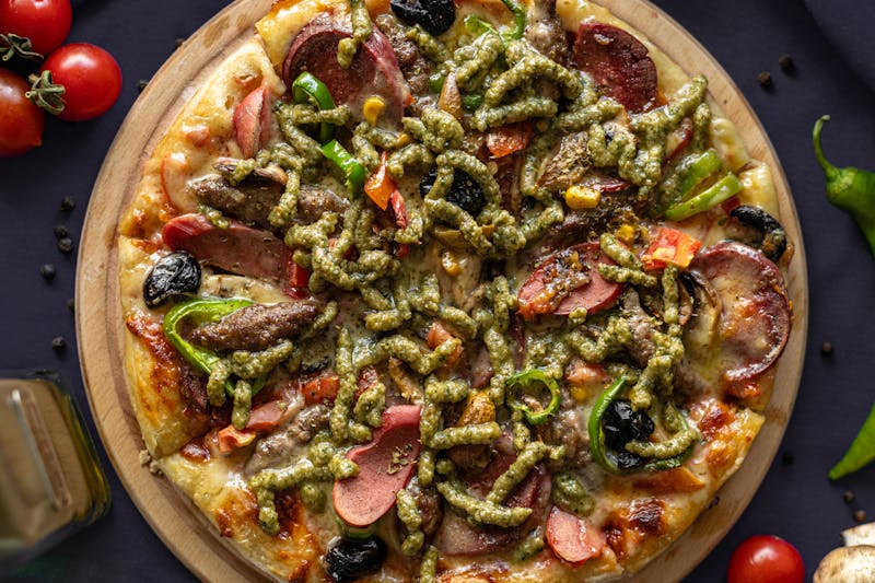 Pesto Primavera veggie pizza with basil pesto and spring vegetables